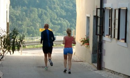 Radol'ška 10ka — a 10k race in the town of Radovljica, Slovenia — two runners enjoy the views of the Jelovica plateau (Copyright © 2017 Hendrik Böttger / runinternational.eu) 